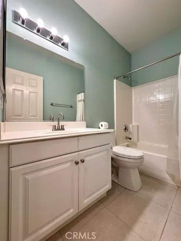 an empty room with a ceiling fan and window