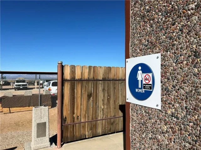 a view of a door and wooden fence