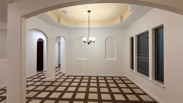 a view of a kitchen with refrigerator and a stove