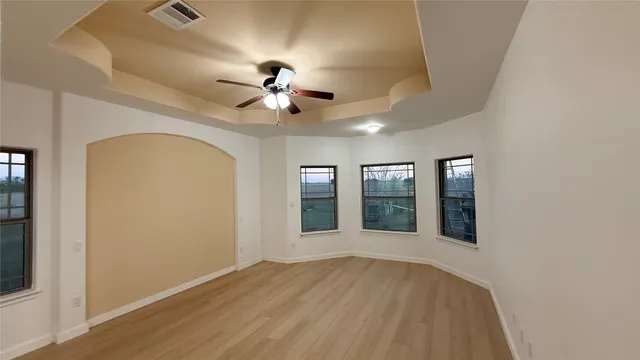wooden floor in an empty room with a window