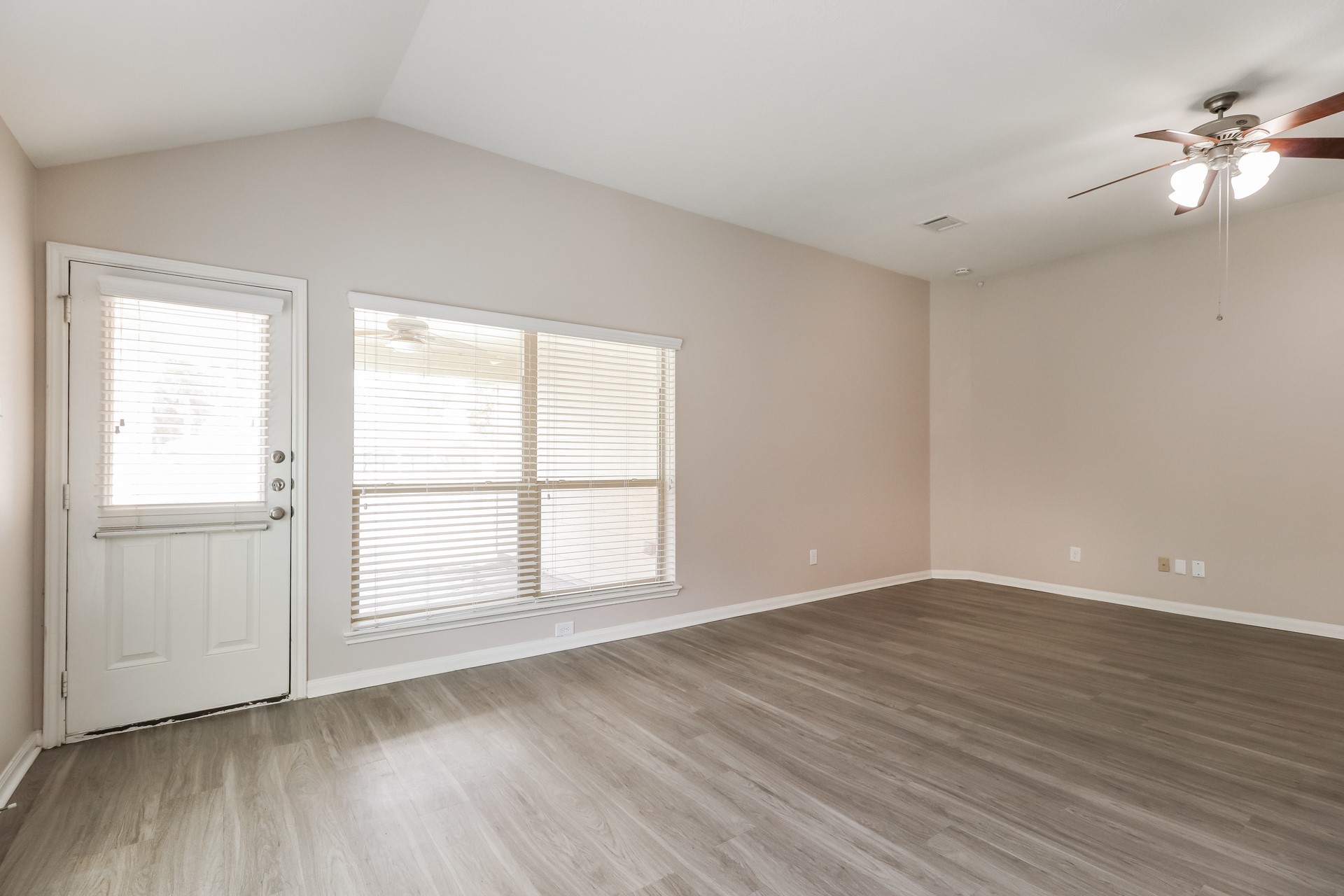 603 Lake View Drive Montgomery, TX 77356 - Photo 3 of 16 an empty room with wooden floor and windows