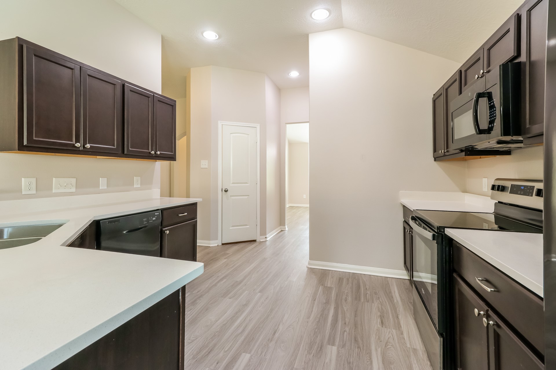 603 Lake View Drive Montgomery, TX 77356 - Photo 8 of 16 a kitchen with stainless steel appliances granite countertop a sink stove and microwave