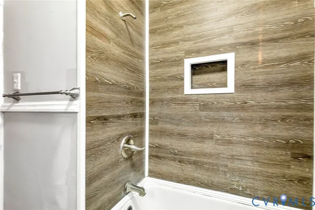 a bathroom with a shower and a sink