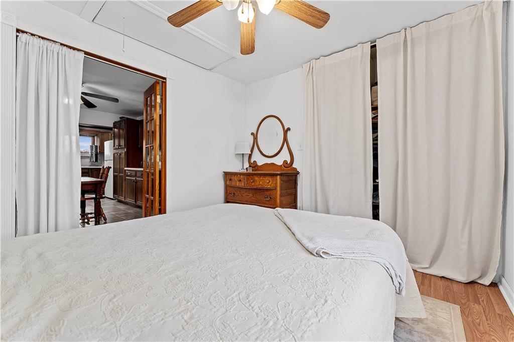 205 Nilan Hill Road Point Marion, PA 15474 - Photo 13 of 22 a bedroom with a bed and a chandelier