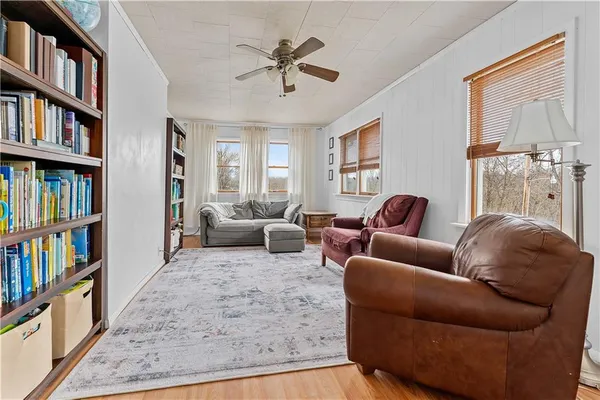 a living room with furniture cabinets and a book shelf