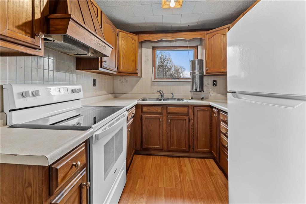 205 Nilan Hill Road Point Marion, PA 15474 - Photo 10 of 22 a kitchen with a sink a stove and cabinets