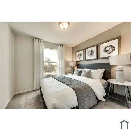 a bedroom with a bed and painting on the wall