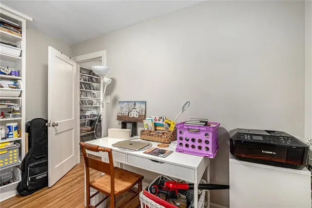 a utility room with stainless steel appliances furniture a rug and a computer on a table