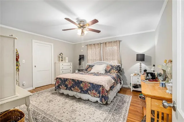 a spacious bedroom with a bed a couch and dresser