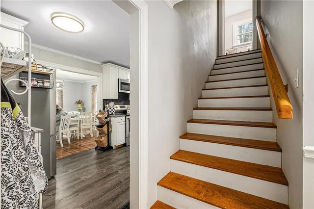 a view of entryway and hall with wooden floor