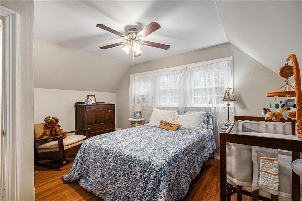 139 Myrtle Street Toccoa, GA 30577 - Photo 21 of 42 a bedroom with a bed and a chandelier