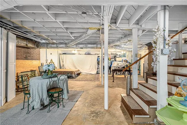 a view of a livingroom with furniture wooden floor and windows