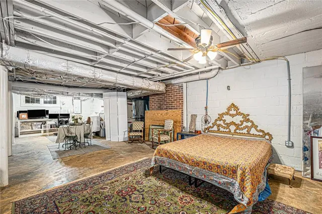 a spacious bedroom with a bed a table and chairs