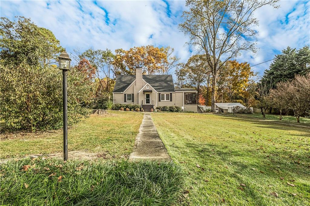 139 Myrtle Street Toccoa, GA 30577 - Photo 35 of 42 a white house with a yard and sitting area