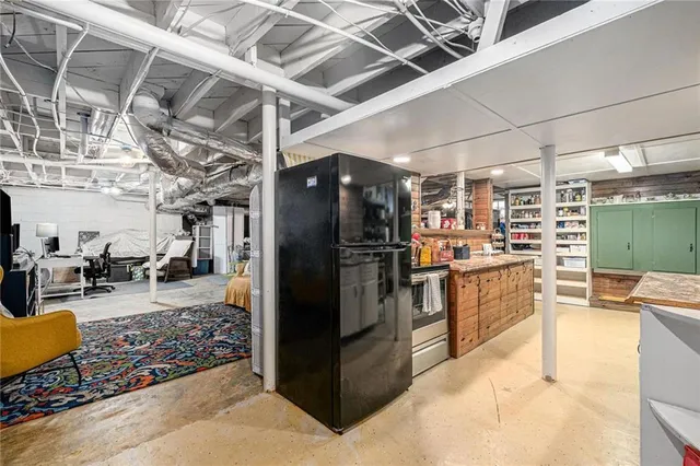a kitchen with stainless steel appliances kitchen island granite countertop a refrigerator and blue cabinets