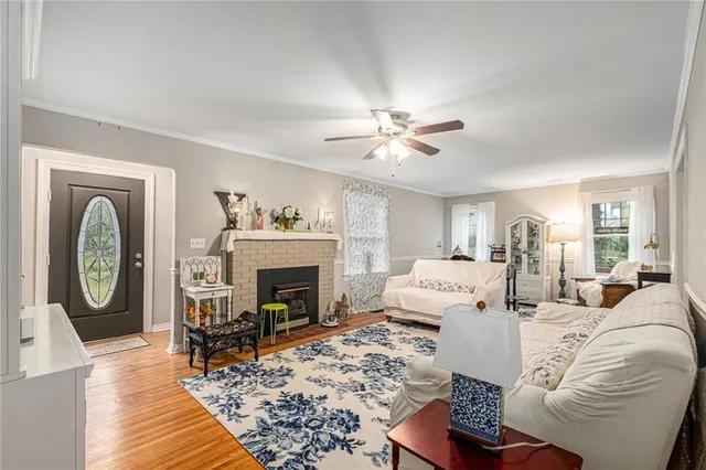 a living room with furniture a fireplace and a chandelier