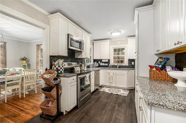 a kitchen with a stove a sink and a refrigerator