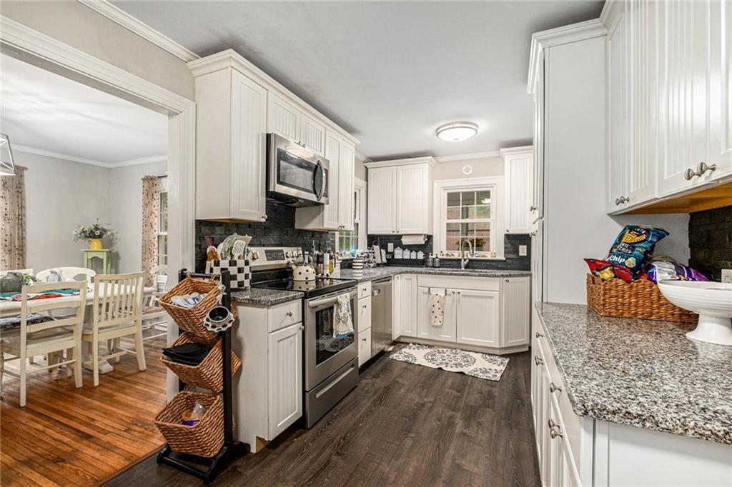 139 Myrtle Street Toccoa, GA 30577 - Photo 8 of 42 a kitchen with a stove a sink and a refrigerator