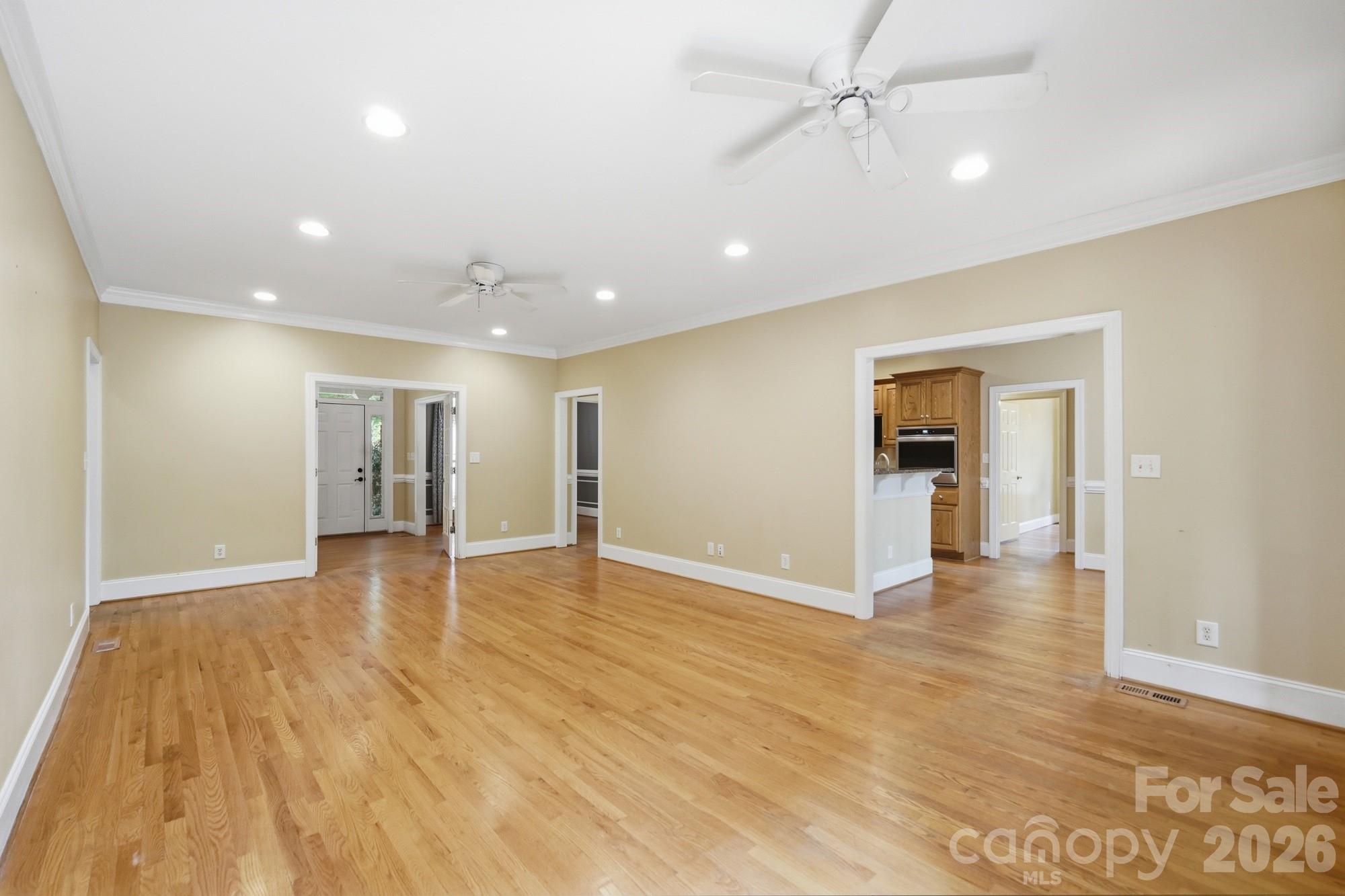 2811 Belk Mill Road Wingate, NC 28174 - Photo 12 of 36 a view of empty room with wooden floor and kitchen
