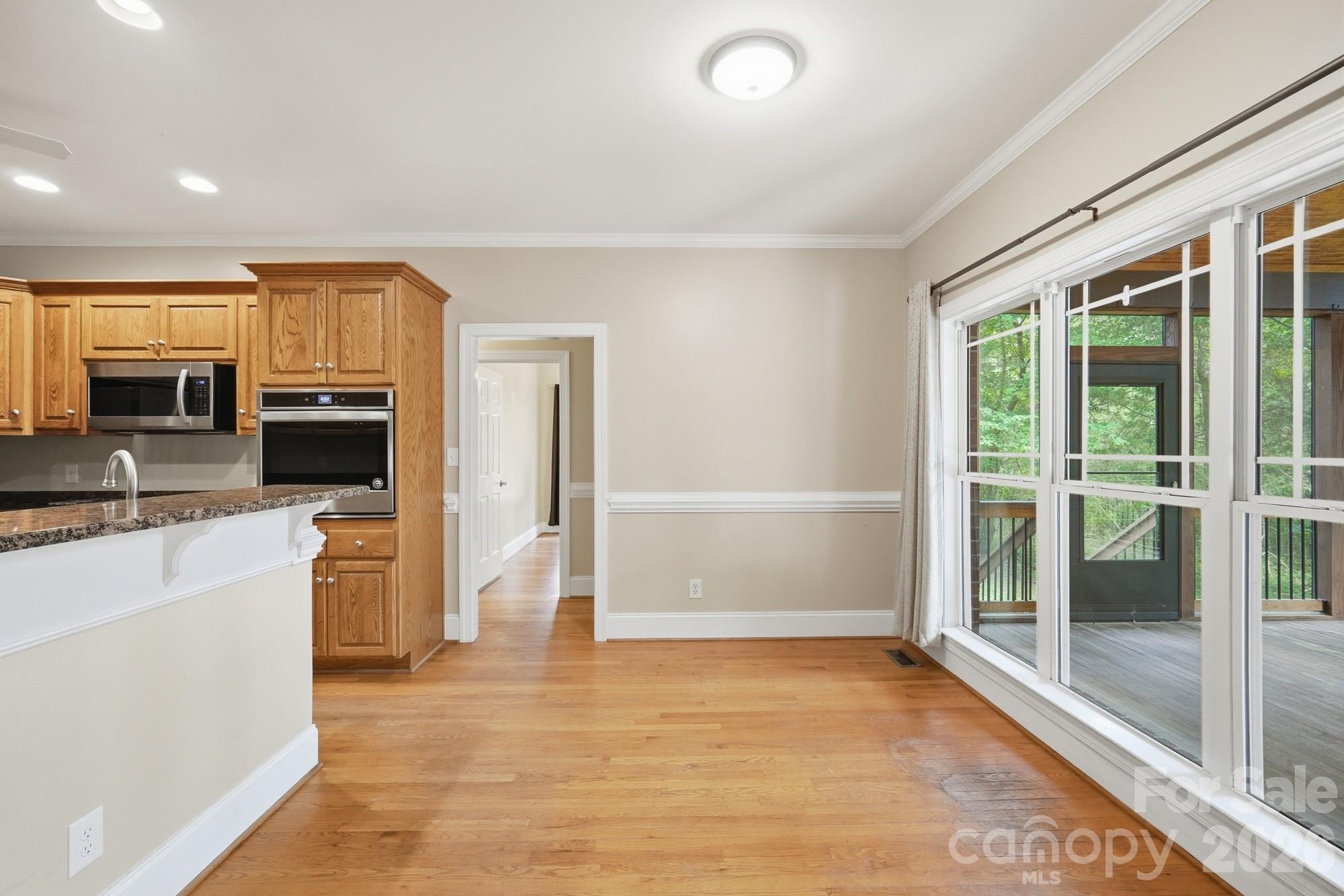 2811 Belk Mill Road Wingate, NC 28174 - Photo 13 of 36 a view of living room with stainless steel appliances wooden floor and large window