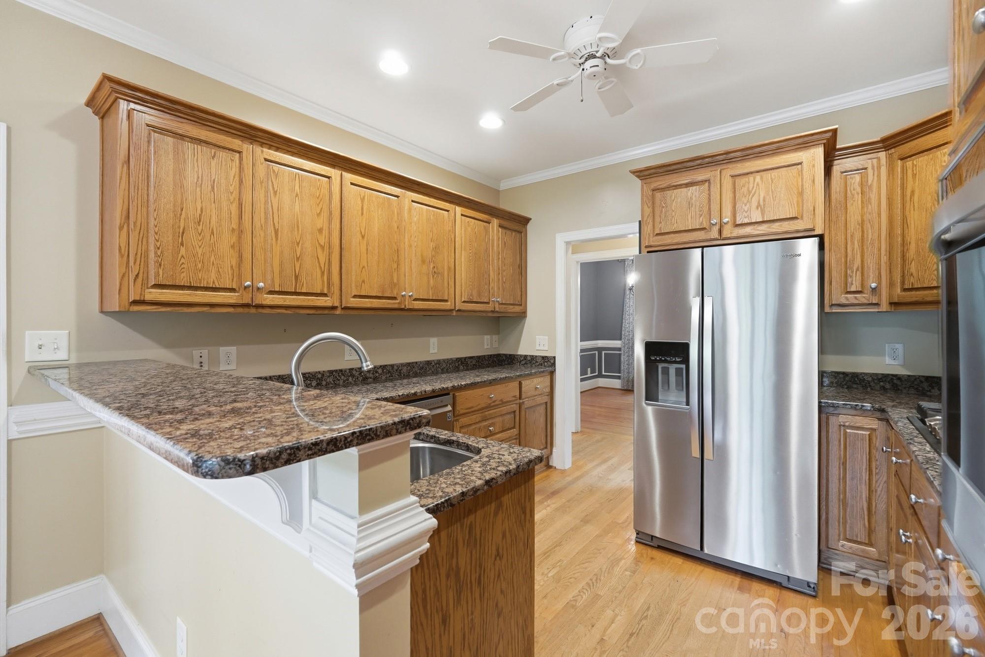 2811 Belk Mill Road Wingate, NC 28174 - Photo 15 of 36 a kitchen with stainless steel appliances granite countertop a refrigerator stove and sink