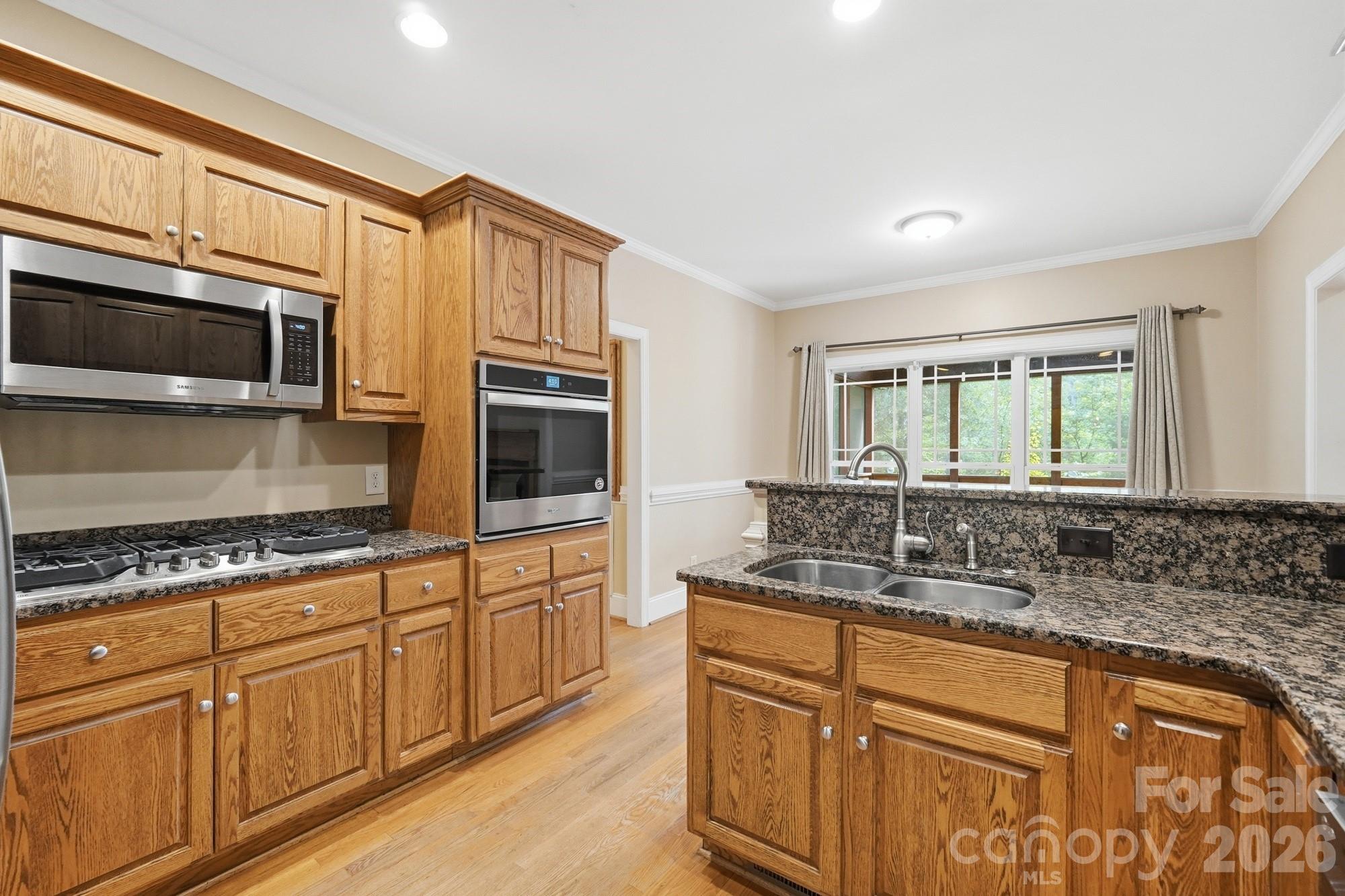 2811 Belk Mill Road Wingate, NC 28174 - Photo 16 of 36 a kitchen with stainless steel appliances granite countertop a sink stove and microwave