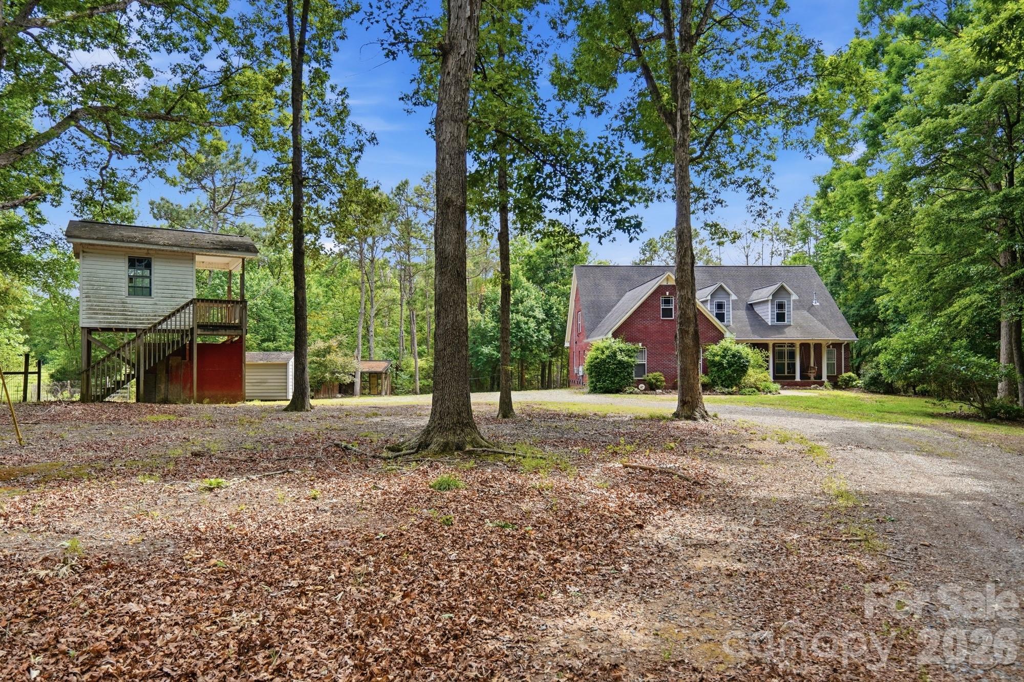 2811 Belk Mill Road Wingate, NC 28174 - Photo 2 of 36 a house with trees in front of it