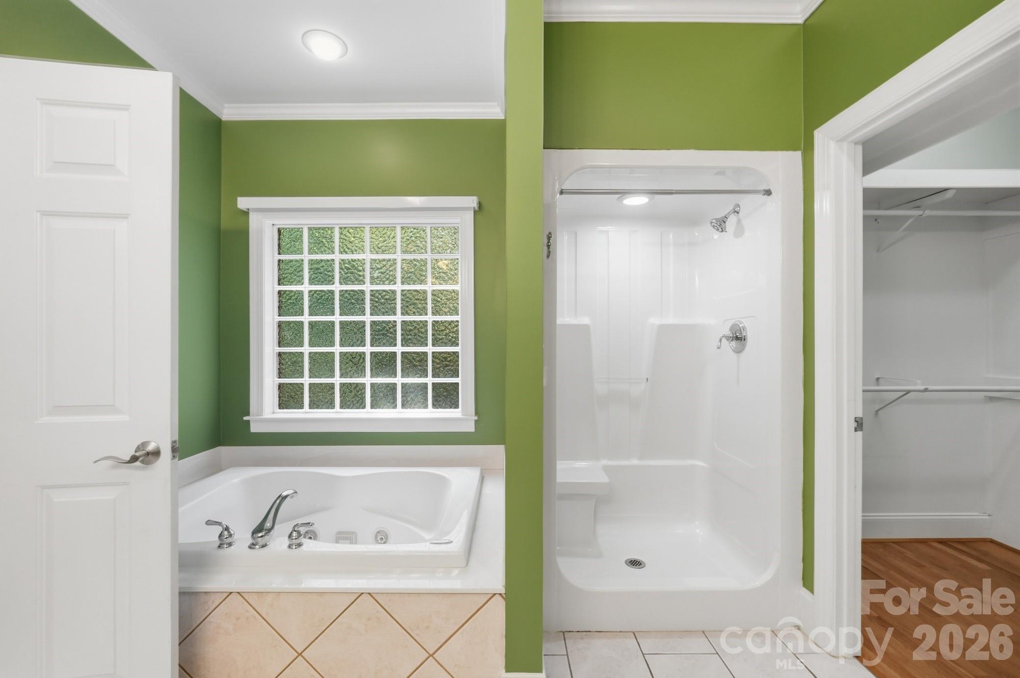 2811 Belk Mill Road Wingate, NC 28174 - Photo 22 of 36 a bathroom with a bathtub and a shower