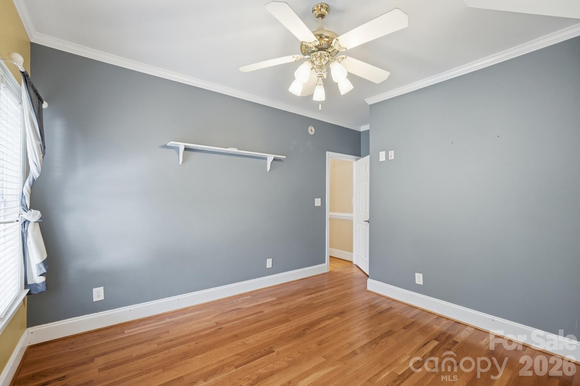 2811 Belk Mill Road Wingate, NC 28174 - Photo 28 of 36 an empty room with wooden floor and fan
