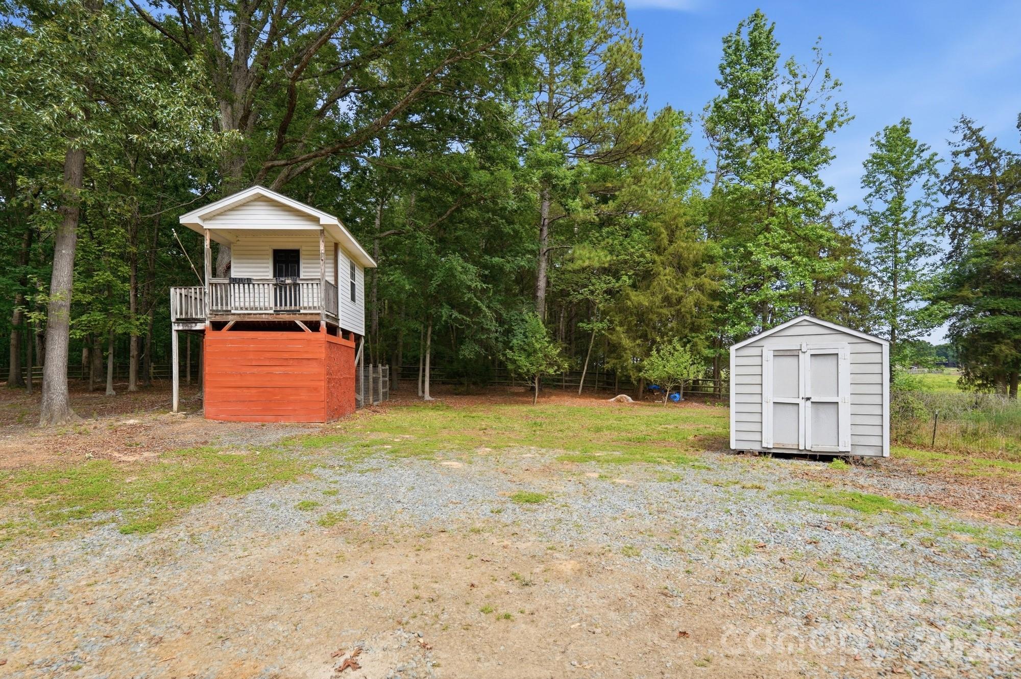 2811 Belk Mill Road Wingate, NC 28174 - Photo 3 of 36 a house with trees in the background