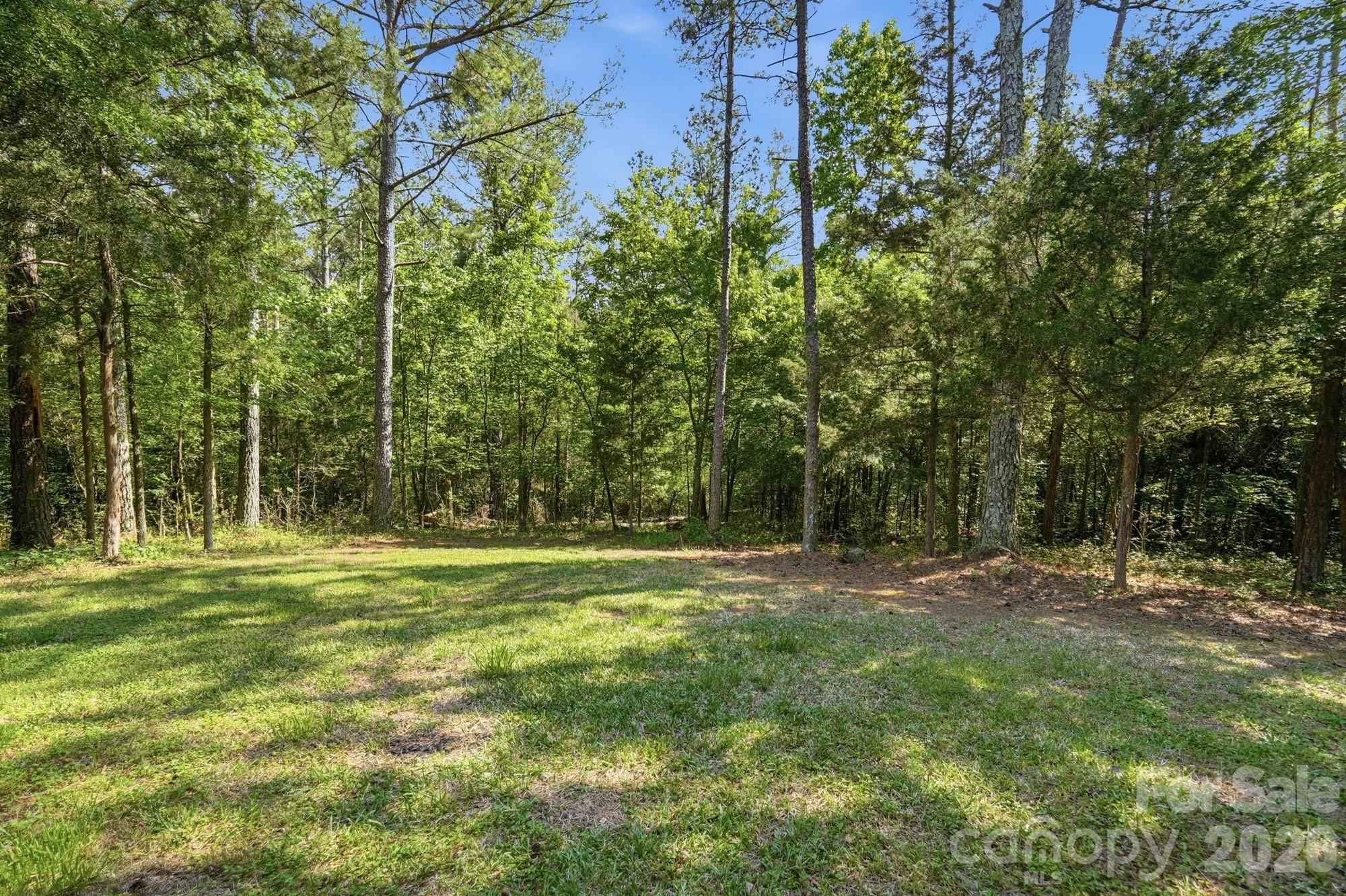 2811 Belk Mill Road Wingate, NC 28174 - Photo 34 of 36 a big yard with lots of green space and trees