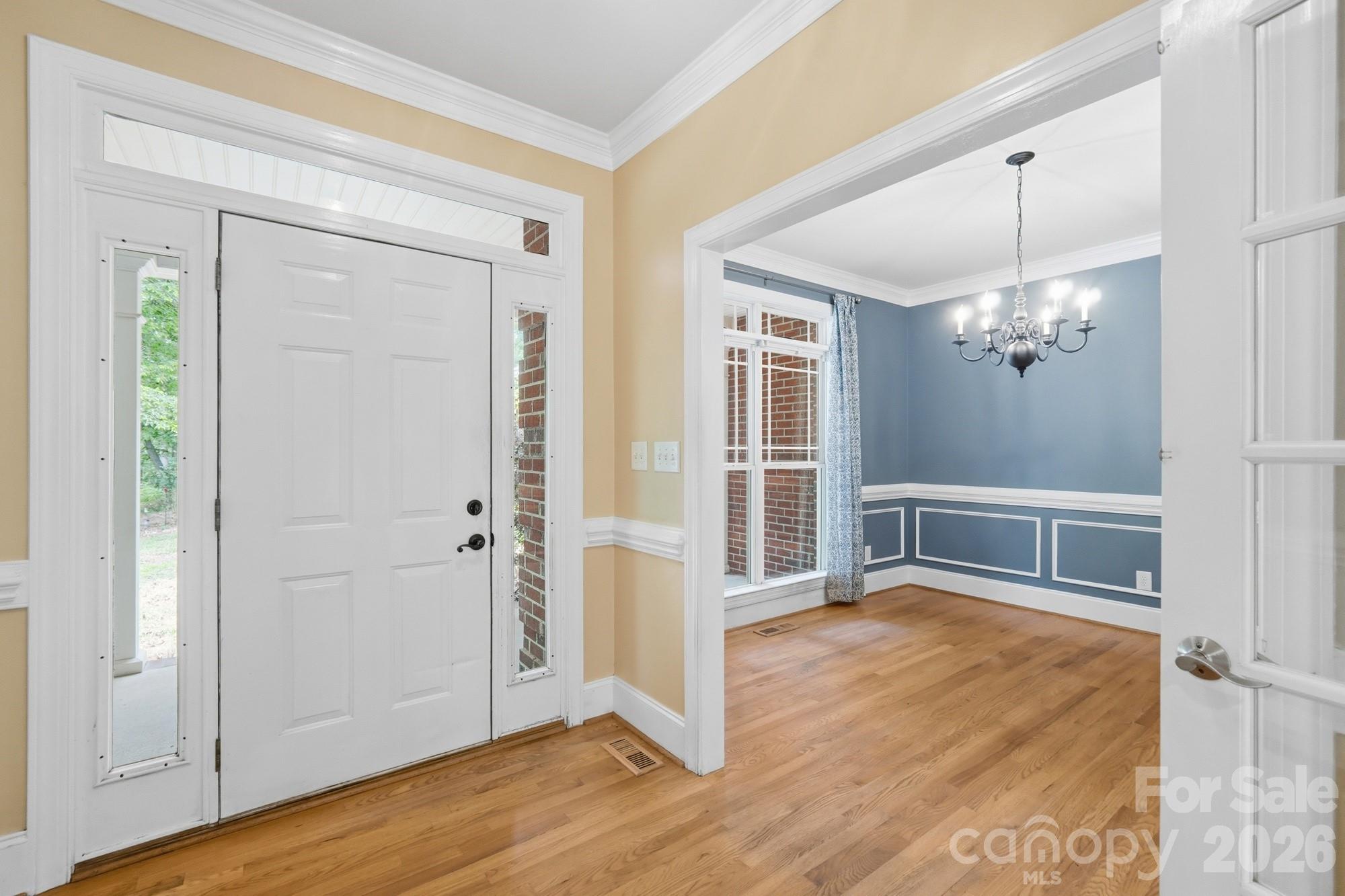 2811 Belk Mill Road Wingate, NC 28174 - Photo 8 of 36 an empty room with wooden floor cabinet and windows