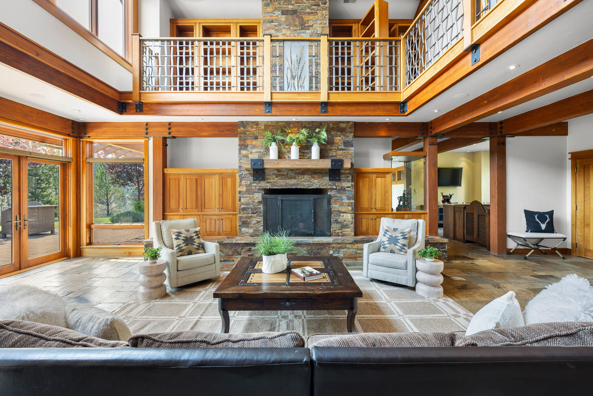 18883 Sutherland Court Bend, OR 97702 - Photo 4 of 70 The heart of the home?soaring ceilings, rich cherry wood, and a statement stone fireplace create an atmosphere of mountain elegance.