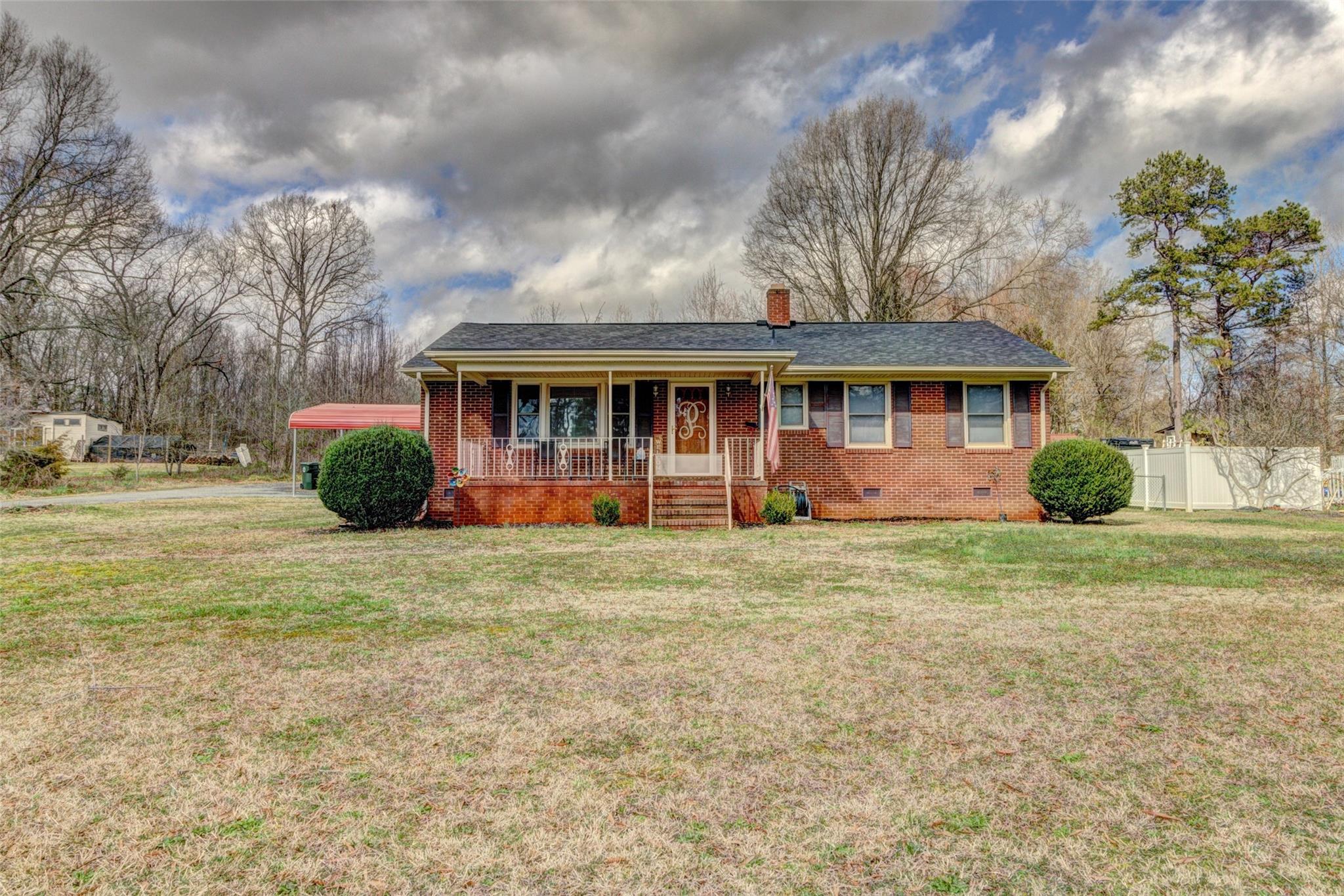 443 Roy Eaker Road Cherryville, NC 28021 - Photo 1 of 15 a front view of a house with a garden