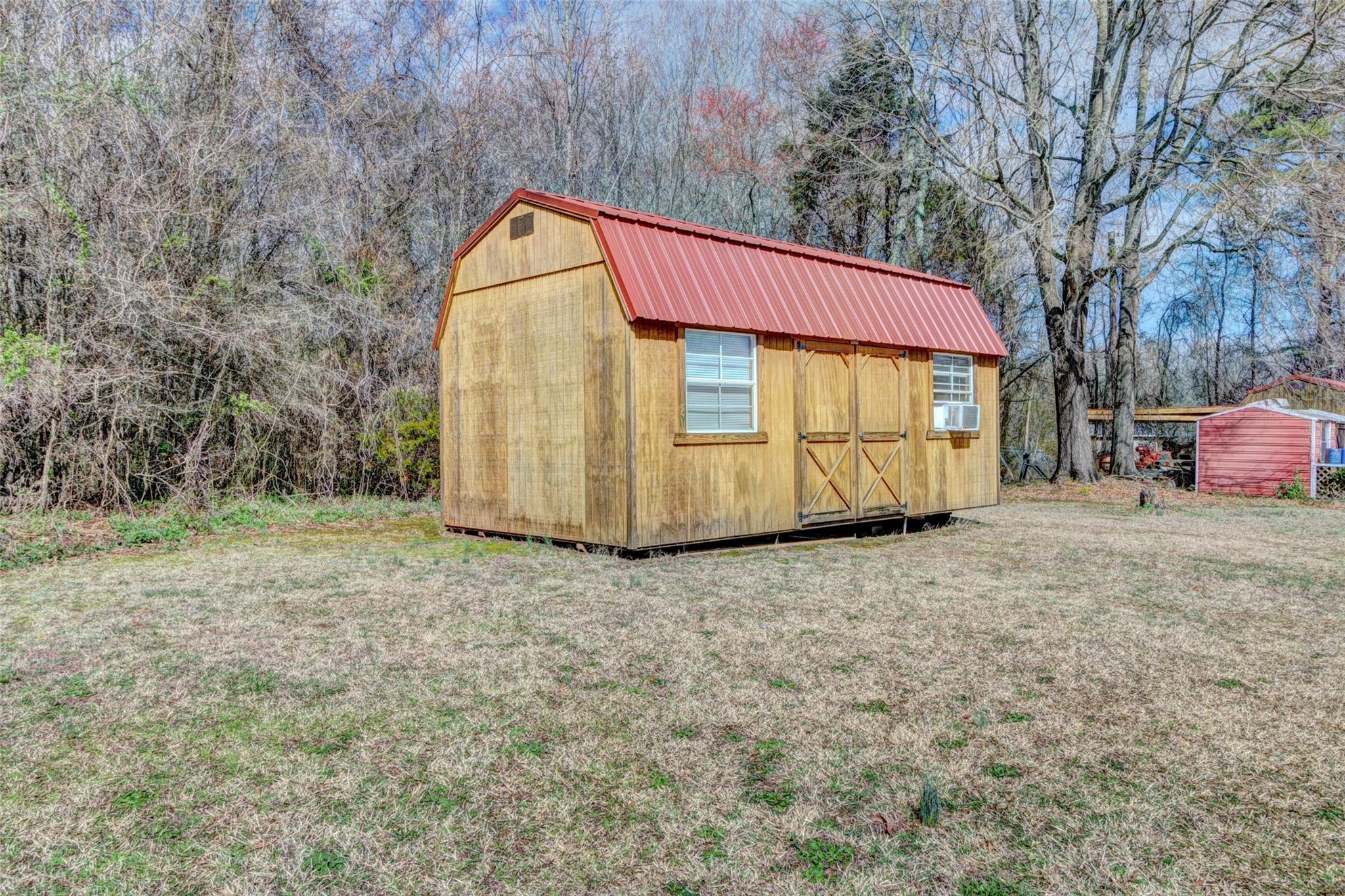 443 Roy Eaker Road Cherryville, NC 28021 - Photo 15 of 15 a backyard of a house with wooden fence and a large tree