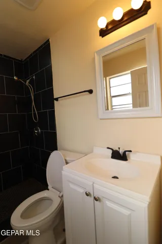 a view of a hallway with wooden cabinets