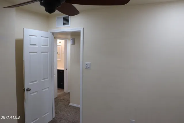 a view of a hallway with wooden floor and closet