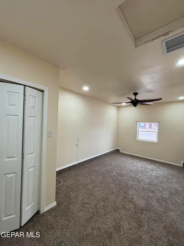 an empty room with closet area