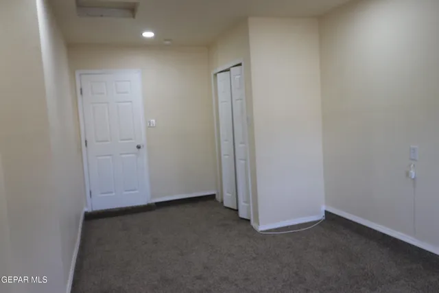 an empty room with a ceiling fan and a ceiling fan