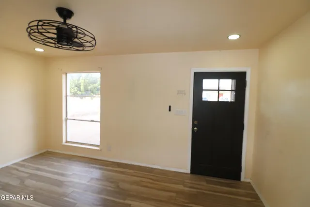 a view of a room with wooden floor and cabinet space