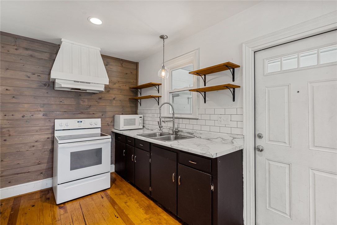 419 Whitehall Road Anderson, SC 29625 - Photo 10 of 28 A well-lit culinary space features bright white countertops and rich wood flooring.