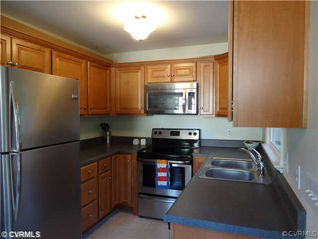 7312 Drexelbrook Road Chesterfield, VA 23832 - Photo 2 of 18 a kitchen with stainless steel appliances granite countertop a refrigerator a stove a sink and a microwave