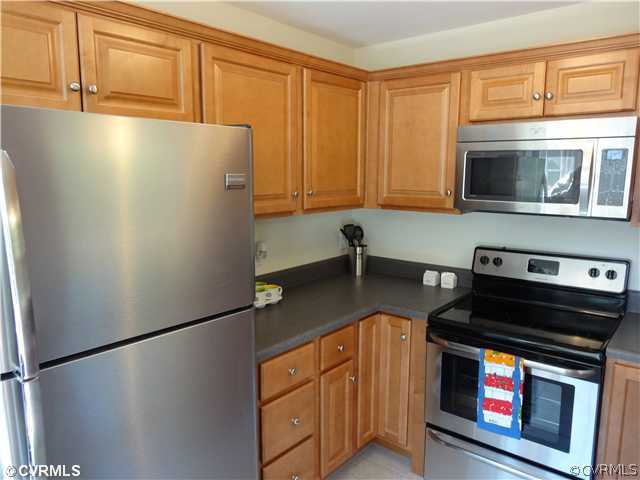 7312 Drexelbrook Road Chesterfield, VA 23832 - Photo 3 of 18 a kitchen with stainless steel appliances granite countertop a refrigerator a stove a sink dishwasher and microwave oven with cabinets