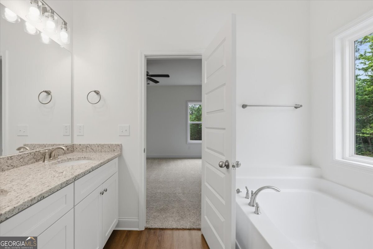 2778 Boxankle Road Forsyth, GA 31029 - Photo 15 of 21 a spacious bathroom with a granite countertop tub sink and mirror