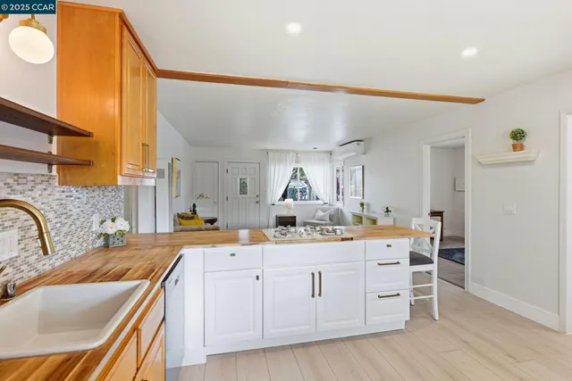 a kitchen with stainless steel appliances granite countertop a refrigerator and wooden cabinets