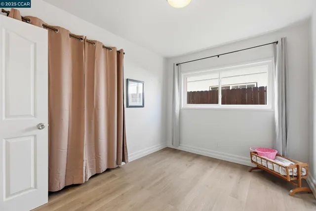 a view of room with window and a ceiling fan
