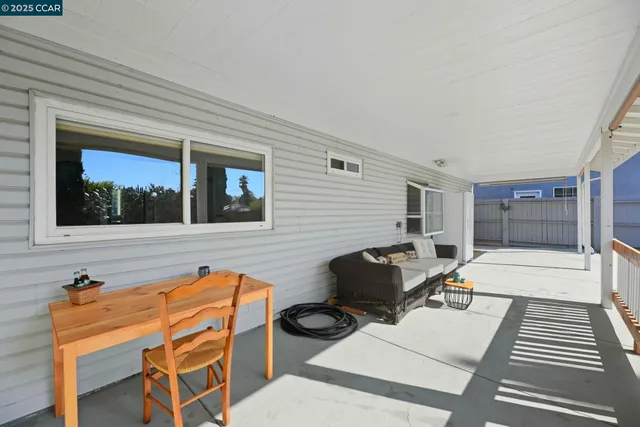 a backyard of a house with table and chairs