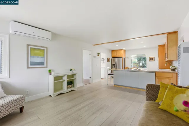 a living room with furniture and view of kitchen
