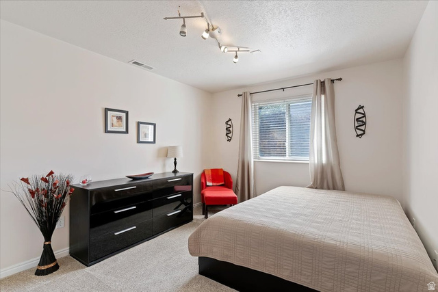 1924 North 2000th Street East Layton, UT 84040 - Photo 34 of 41 Bedroom with light carpet and a textured ceiling