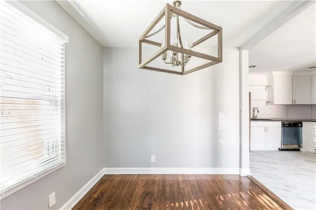 a view of hallway with wooden floor and staircase
